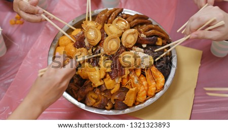 Traditional Chinese family eating big bowl feast together at home