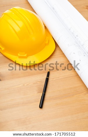 Construction blue print and safety helmet