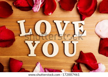 Love you wooden text and rose petal