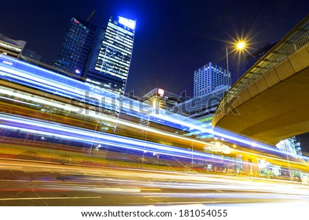 Fast moving car light in city at night