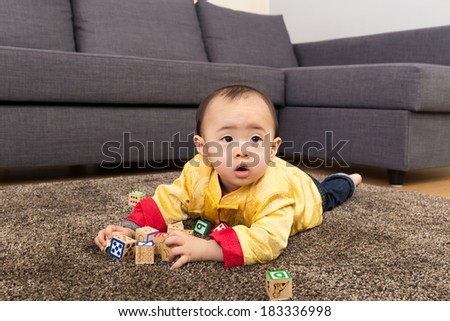 Chinese baby boy play toy block at home