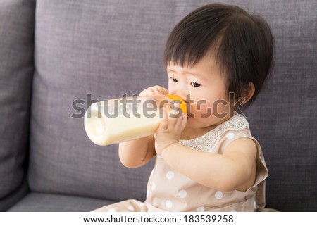 Asia baby girl feeding with milk bottle