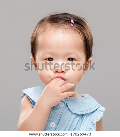 Baby put finger into mouth