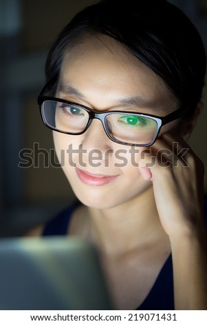 Woman look at computer screen at night