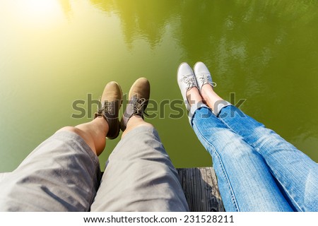 Woman and man legs in water pond