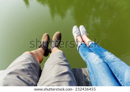 Couple legs wite lake
