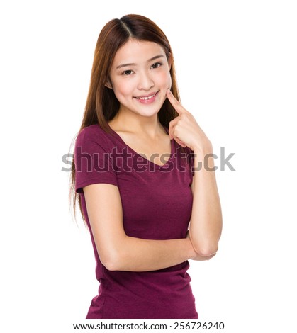 Asian woman finger point to her teeth