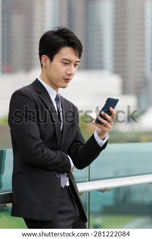 Asian business check email on smart phone