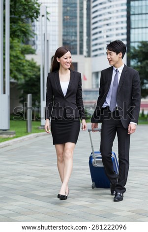Businessman carry luggage for his business trip with his colleague