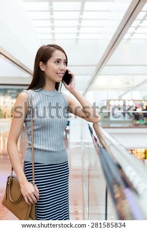 Woman talk to mobile phone at department store