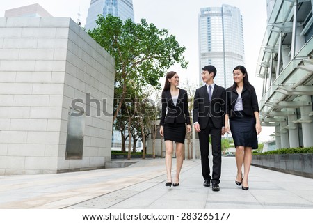 Group of business people walking along the street at outdoor in Hong Kong