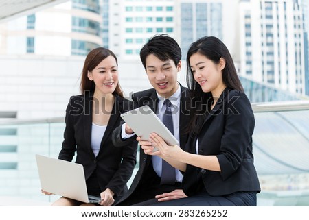 Business partner work together with laptop computer and tablet at outdoor