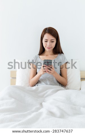 Woman checking the news on mobile phone at morning