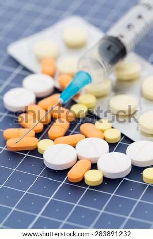 Medical pills and injection syringe