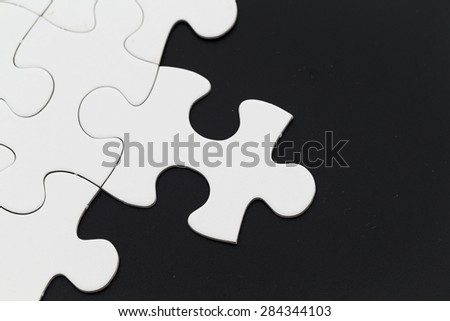 Plain white jigsaw puzzle on Black background