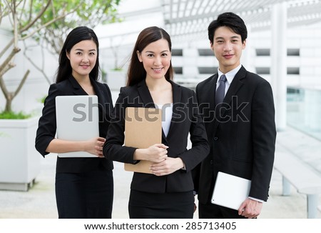 Confident business people hold with clipboard and digital device