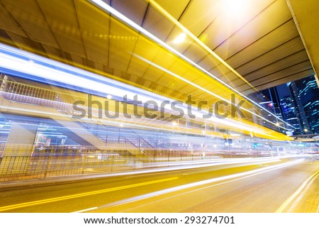 Fast moving car at night in modern city