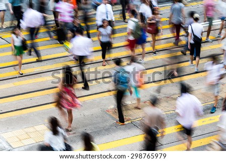 Motion blurred pedestrians crossing Hong Kong street