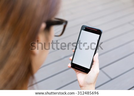 Woman use of the mobile phone with blank screen