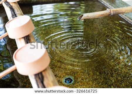 Water purification at entrance of the Japanese temple