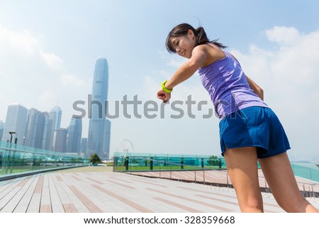 Sporty woman looking at the wearable watch when running