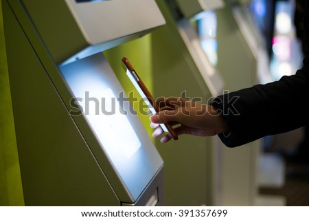 Woman scanning on the payment machine by NFC