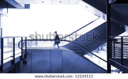 business man moving on escalator