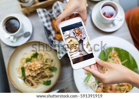 Cellphone taking photo on food from top view