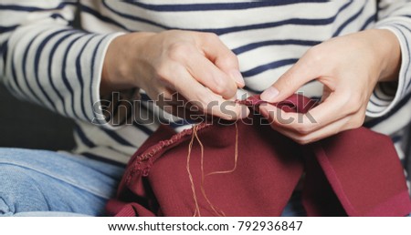 Hand Sews with a needle and thread at home