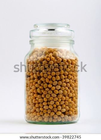 Yellow beans in a glass jar. close up on white background