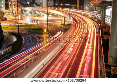 Long exposure image of cars rushing over a highway in central Tokyo, Japan at night