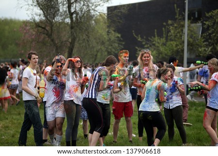 OXFORD - MAY 5: Oxford University students covered in color during Oxford Holi festival on Sunday May 5, 2013 in Oxford, United Kingdom.