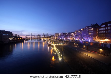 Nightview of Schlachte boulevard in Bremen with christmas market during sunset