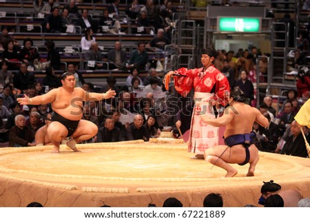 FUKUOKA - NOVEMBER 18: Two sumo wrestlers showing off and preparing for a fight in the Fukuoka Tournament on November 18, 2010 in Fukuoka, Japan.