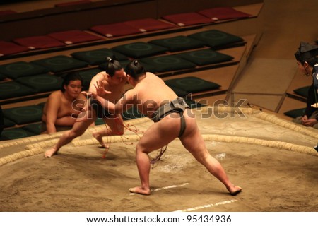 TOKYO - JANUARY 14: Unidentified wrestlers in the Grand Sumo Tournament in Tokyo, Japan on January 14, 2012. Although baseball has surpassed sumo in viewers, it is still Japan\'s national sport