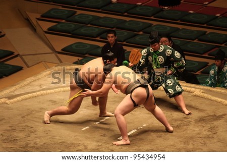 TOKYO - JANUARY 14: Unidentified wrestlers in the Grand Sumo Tournament in Tokyo, Japan on January 14, 2012. Although baseball has surpassed sumo in viewers, it is still Japan\'s national sport