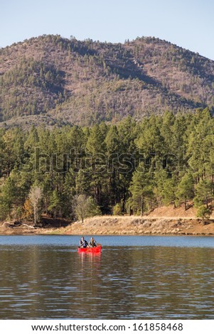 Vertical Landscape of Couple in a Canoe on a Mountain Lake