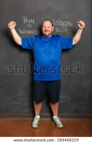 Portrait of Man, in Successful Weight Loss Program, Standing Next to Motivational Quote.