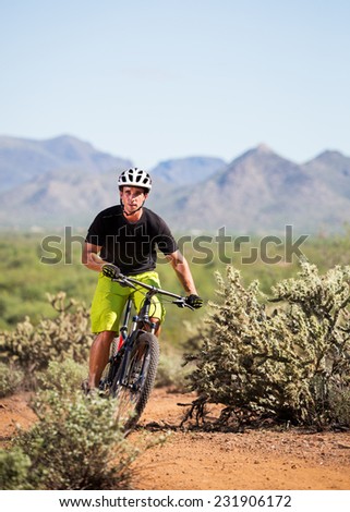 Young Man Riding Mountain Bike in Desert