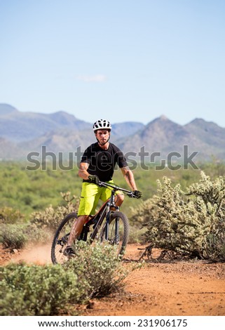 Action Shot of Young Man Riding Mountain Bike in Desert (Dust Behind Back Wheel)