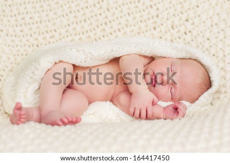 New born baby portrait, lying in blanket