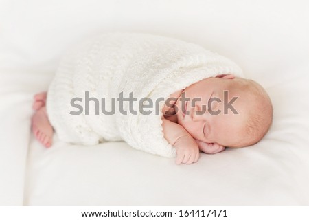 New born baby portrait, lying in blanket