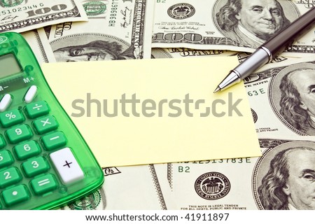 Checkbook open with blank check showing along with a calculator, pen, cash, and credit cards.