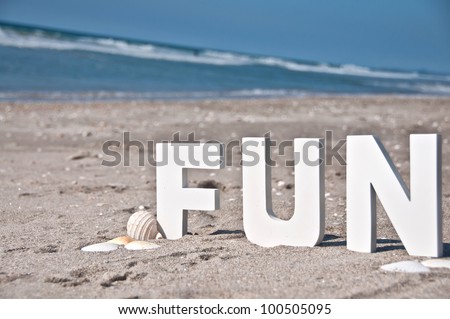 The letters and word fun at the beach block letters sitting in the sand
