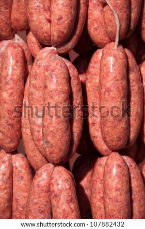 Fresh made beef sausages hanging at a meat market