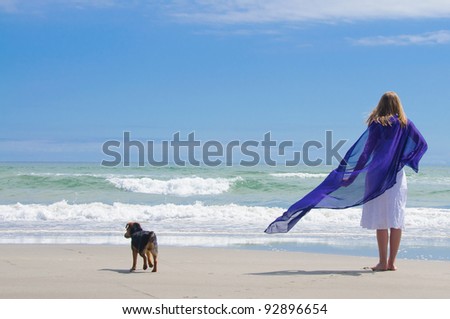At the beach with dog watching the waves