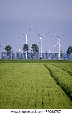 crop fields with wind power stations in the background