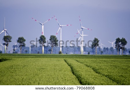 crop fields with wind power stations in the background