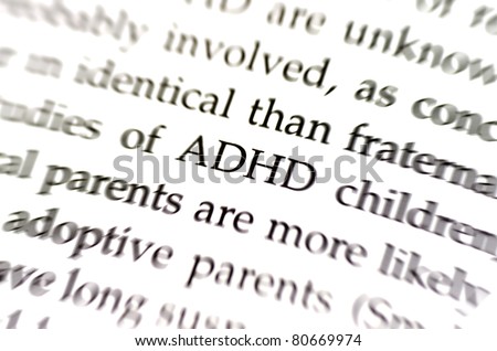 the word adhd in focus surrounded by blurred words