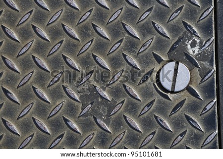 Large Screw and diagonal tred on grungy metal cover